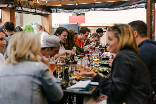 Friends sharing a restaurant meal — who Digestive Harmony is for